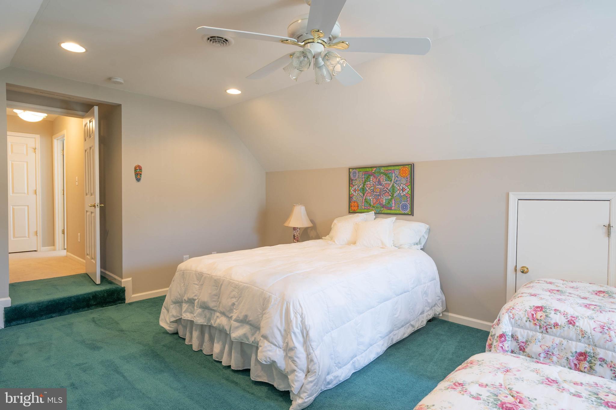 37140 Lord Baltimore Lane Ocean View, DE 19970 - Photo 34 of 56 a bedroom with a bed and a chandelier