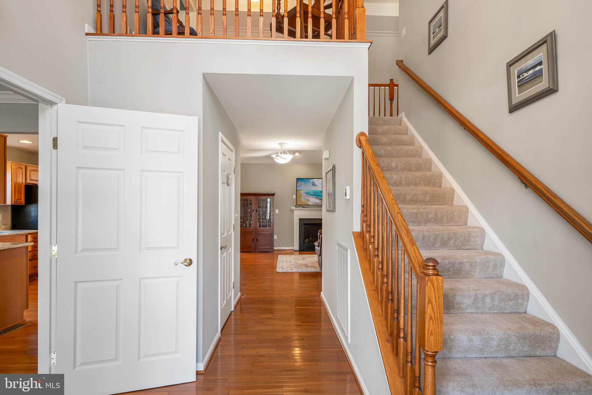 37140 Lord Baltimore Lane Ocean View, DE 19970 - Photo 7 of 56 a view of a hallway with wooden floor and staircase