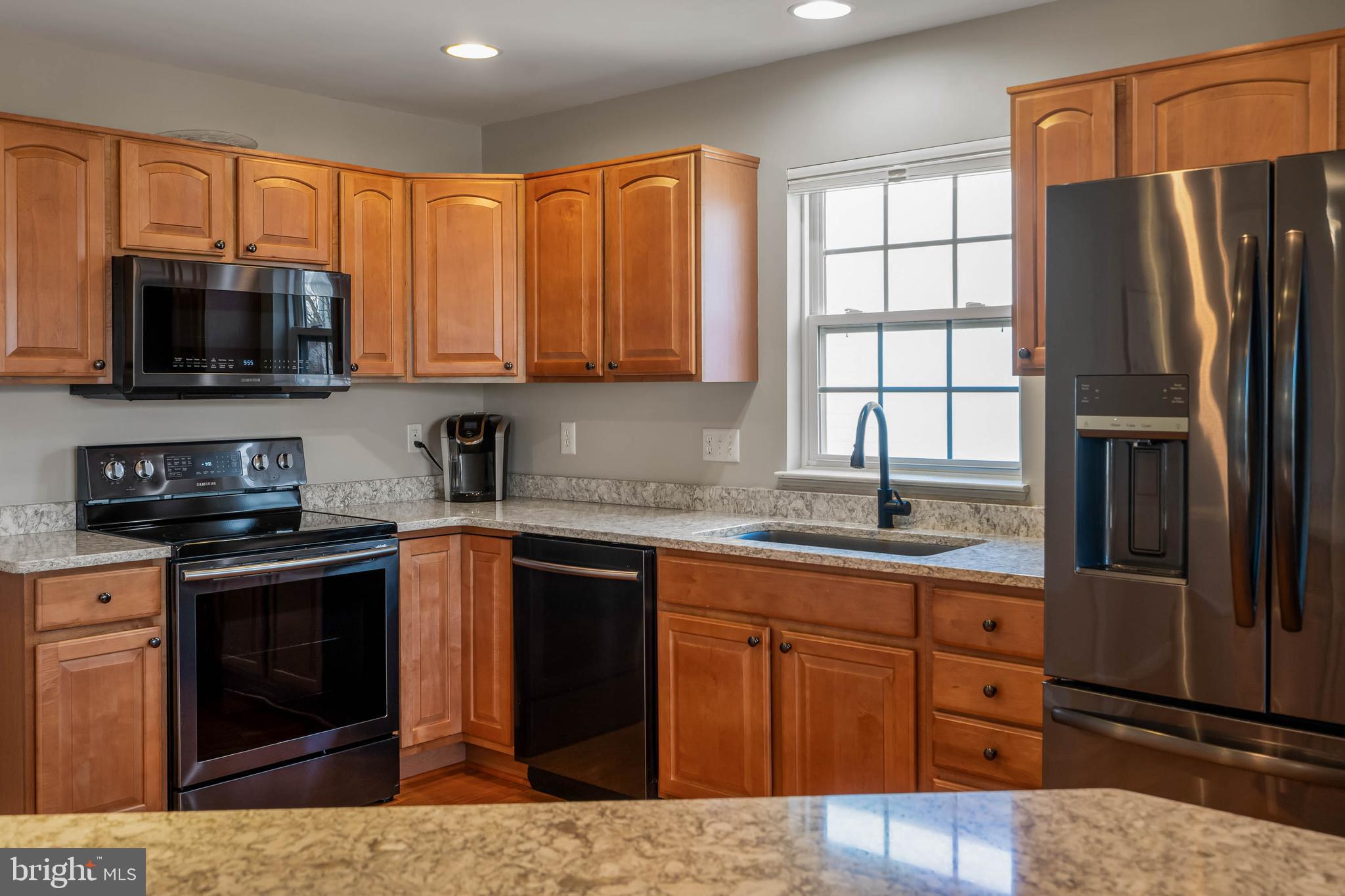 37140 Lord Baltimore Lane Ocean View, DE 19970 - Photo 10 of 56 a kitchen with stainless steel appliances granite countertop a refrigerator stove top oven a sink and dishwasher