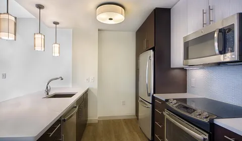a kitchen with a sink and a stove top oven