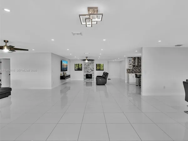 a living room with furniture and a air conditioner vent