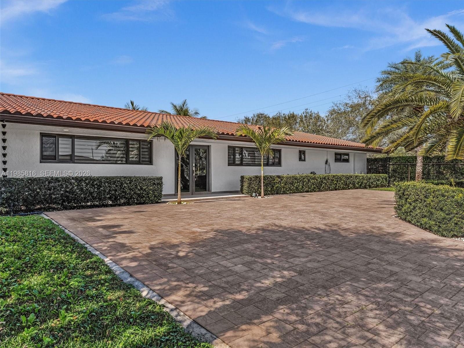 4501 Southwest 133rd Avenue Southwest Ranches, FL 33330 - Photo 2 of 100 a front view of a house with a yard and trees