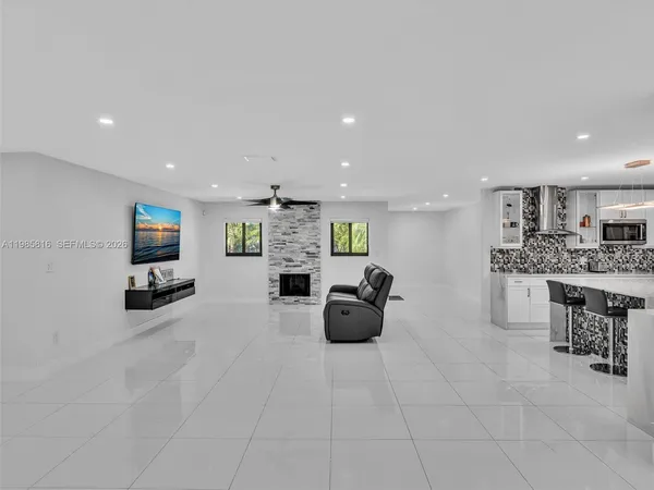 a view of a livingroom with furniture and a flat screen tv