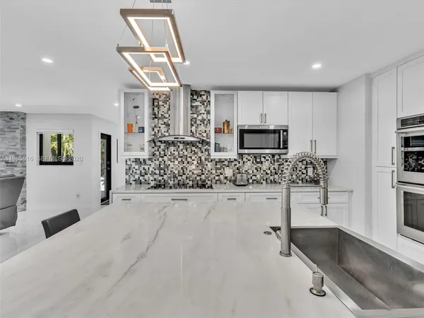 a kitchen with a refrigerator and a sink