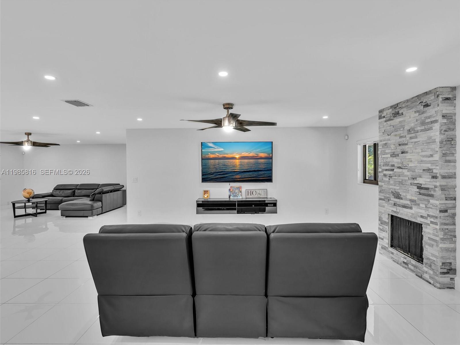 4501 Southwest 133rd Avenue Southwest Ranches, FL 33330 - Photo 39 of 100 a living room with furniture and a flat screen tv