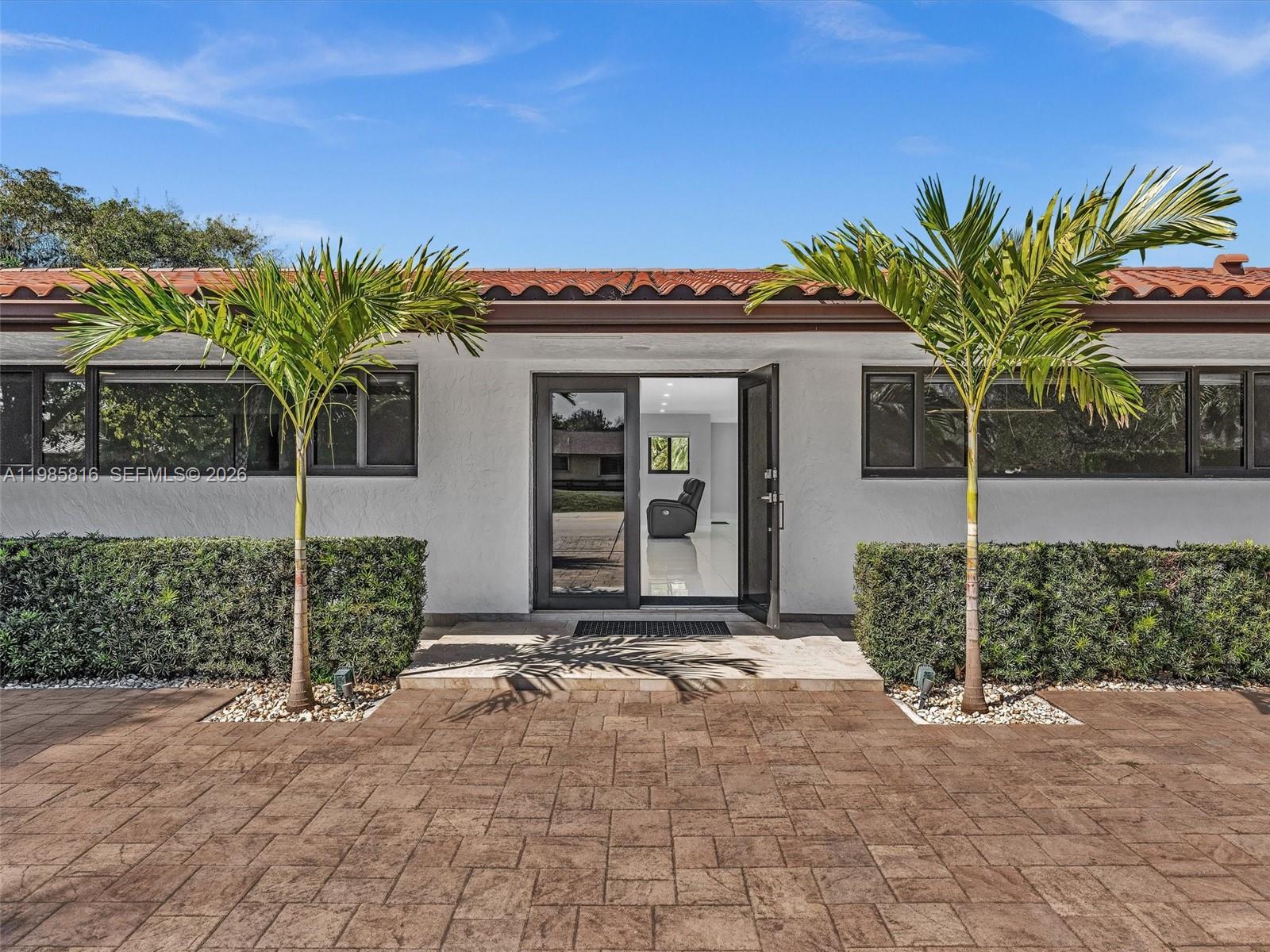 4501 Southwest 133rd Avenue Southwest Ranches, FL 33330 - Photo 5 of 100 a front view of a house with a garden