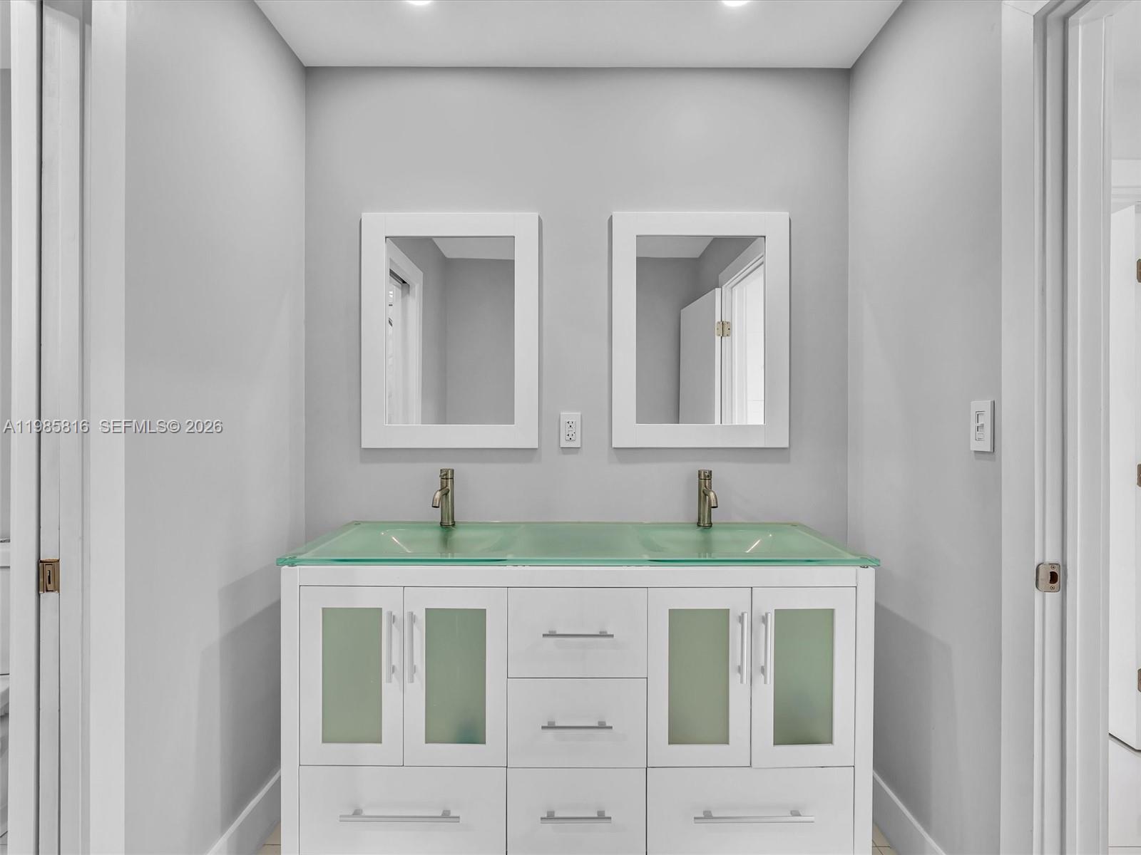 4501 Southwest 133rd Avenue Southwest Ranches, FL 33330 - Photo 52 of 100 a bathroom with a granite countertop sink and a mirror