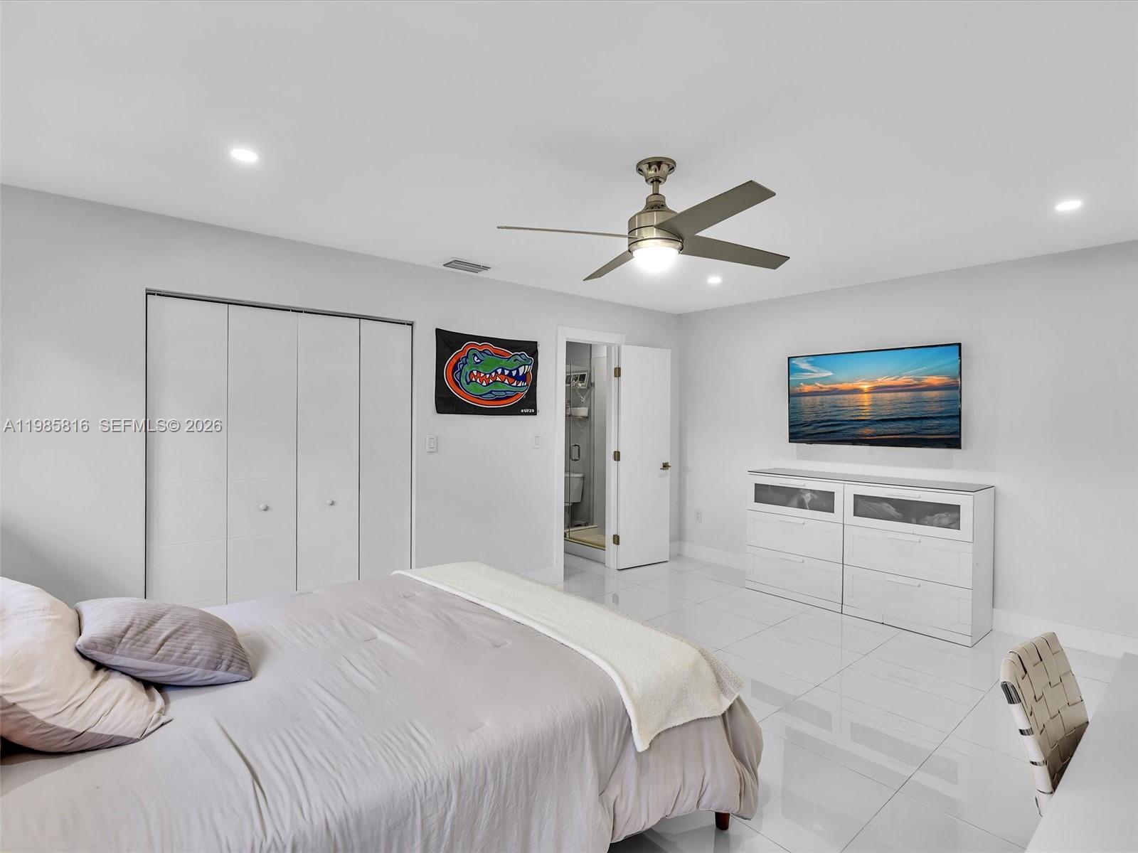 4501 Southwest 133rd Avenue Southwest Ranches, FL 33330 - Photo 65 of 100 a bedroom with a bed and a flat screen tv