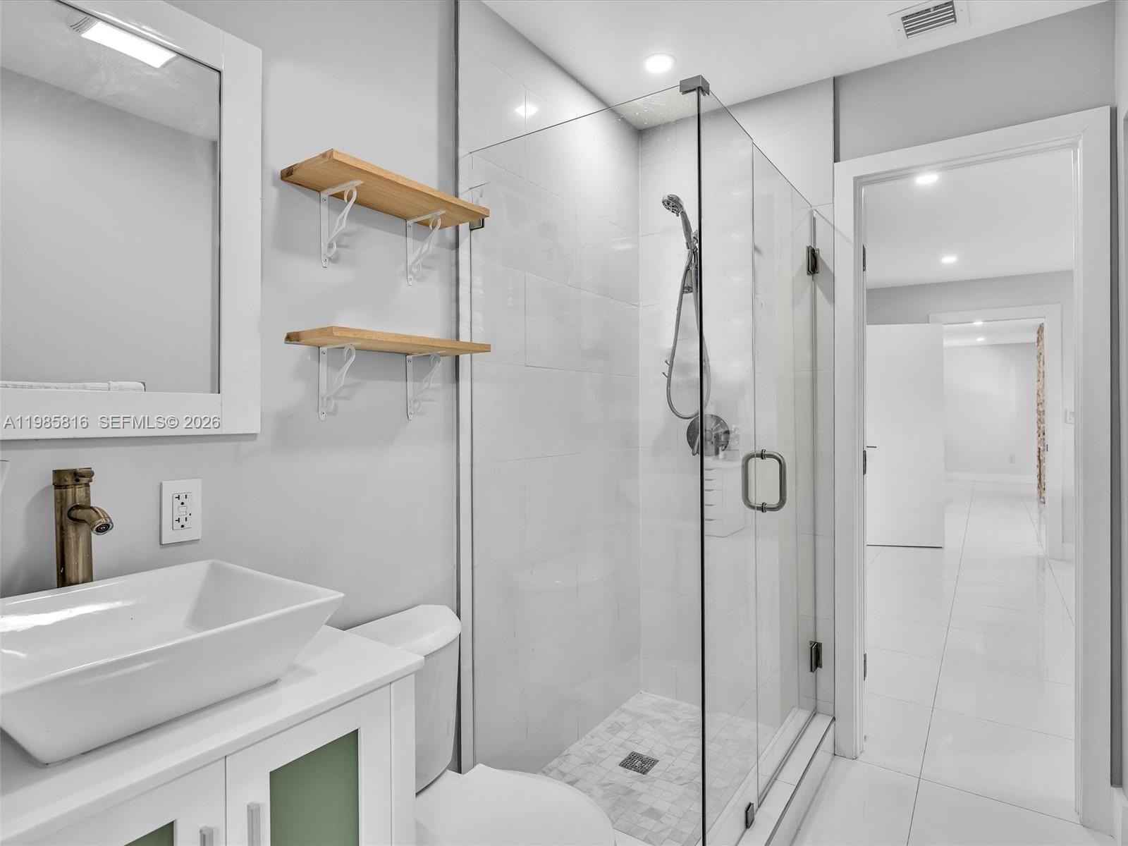 4501 Southwest 133rd Avenue Southwest Ranches, FL 33330 - Photo 69 of 100 a bathroom with a shower sink vanity and toilet
