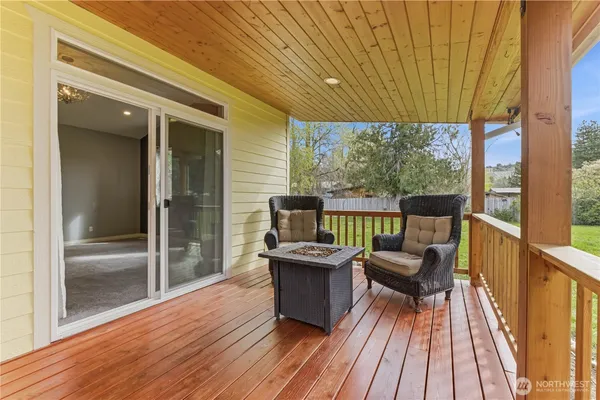 a view of a balcony with chair and wooden floor
