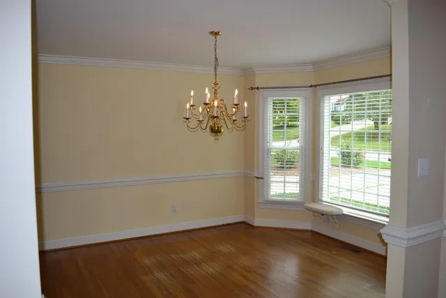 a view of a room with window and wooden floor