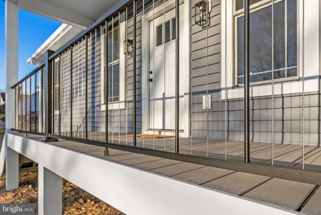 a view of a big house with a big yard and large trees