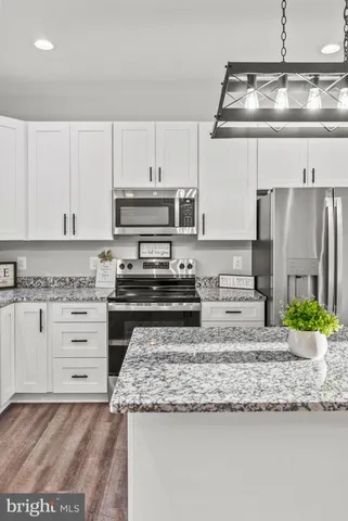a kitchen with granite countertop a sink and a stove