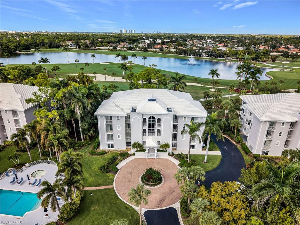 an aerial view of a house with a garden and lake view