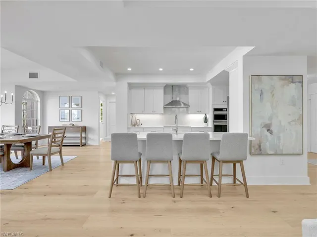a kitchen with white cabinets appliances and sink