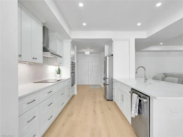 a kitchen with a sink and refrigerator