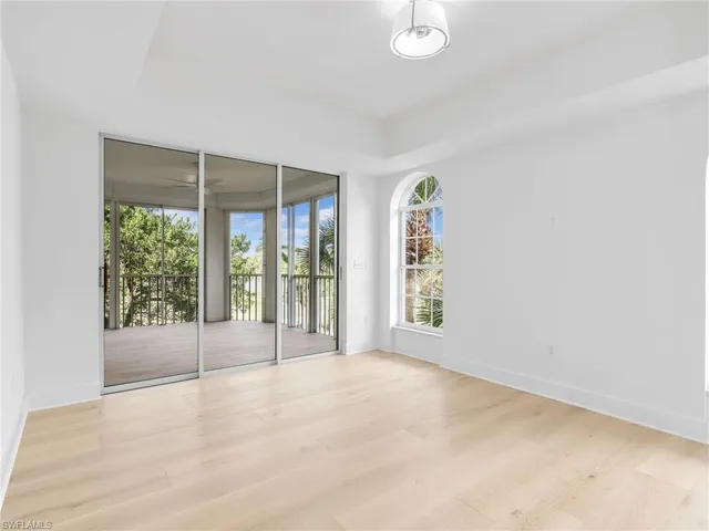 a bedroom with a large bed and a large window