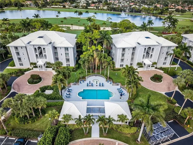 an aerial view of a house with outdoor space pool patio and lake view