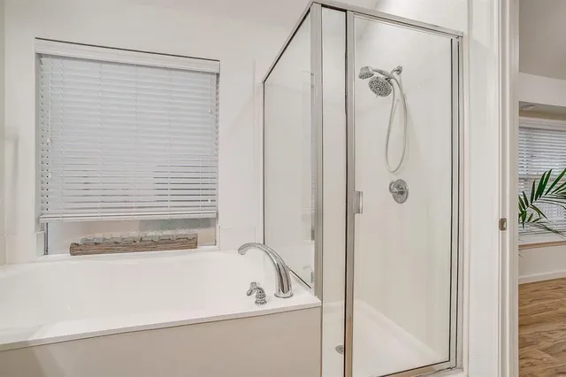 a bathroom with a tub and shower