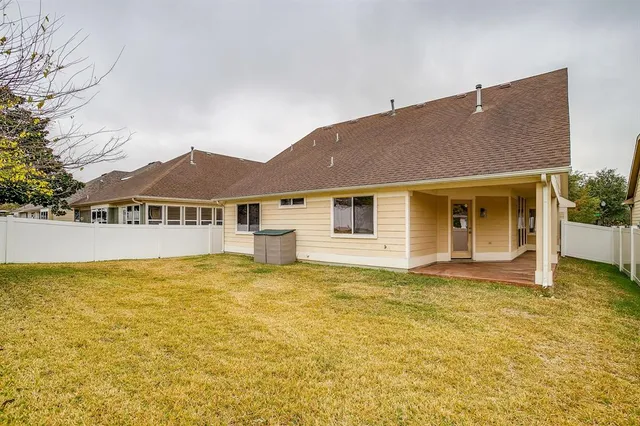 a house that has a large pool in front of it