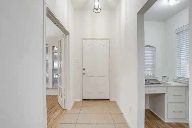 a view of a kitchen & entryway with a sink