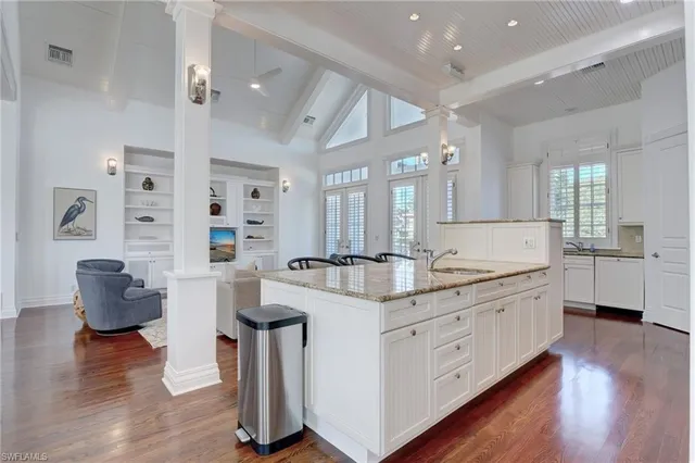 a kitchen with granite countertop white cabinets stainless steel appliances and sink