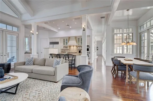 a living room with furniture and floor to ceiling windows