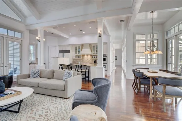 a living room with furniture and floor to ceiling windows