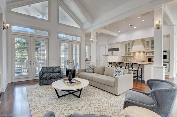 a living room with furniture and large windows