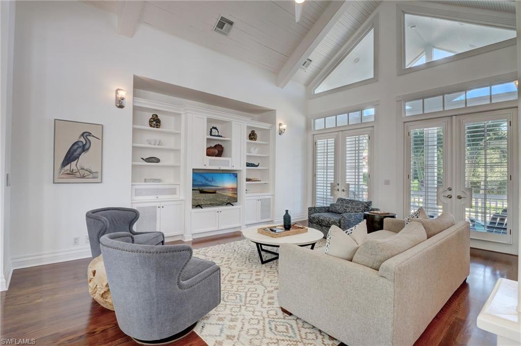 1551 Gulf Shore Boulevard South Naples, FL 34102 - Photo 18 of 44 a living room with furniture and large windows