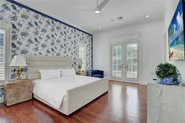 a bathroom with a granite countertop toilet a sink a mirror and a shower