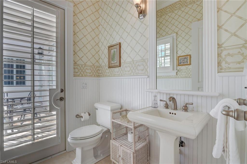 1551 Gulf Shore Boulevard South Naples, FL 34102 - Photo 25 of 44 a bathroom with a sink a toilet and shower