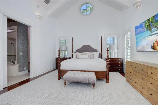 a spacious bedroom with a large bed and a large window