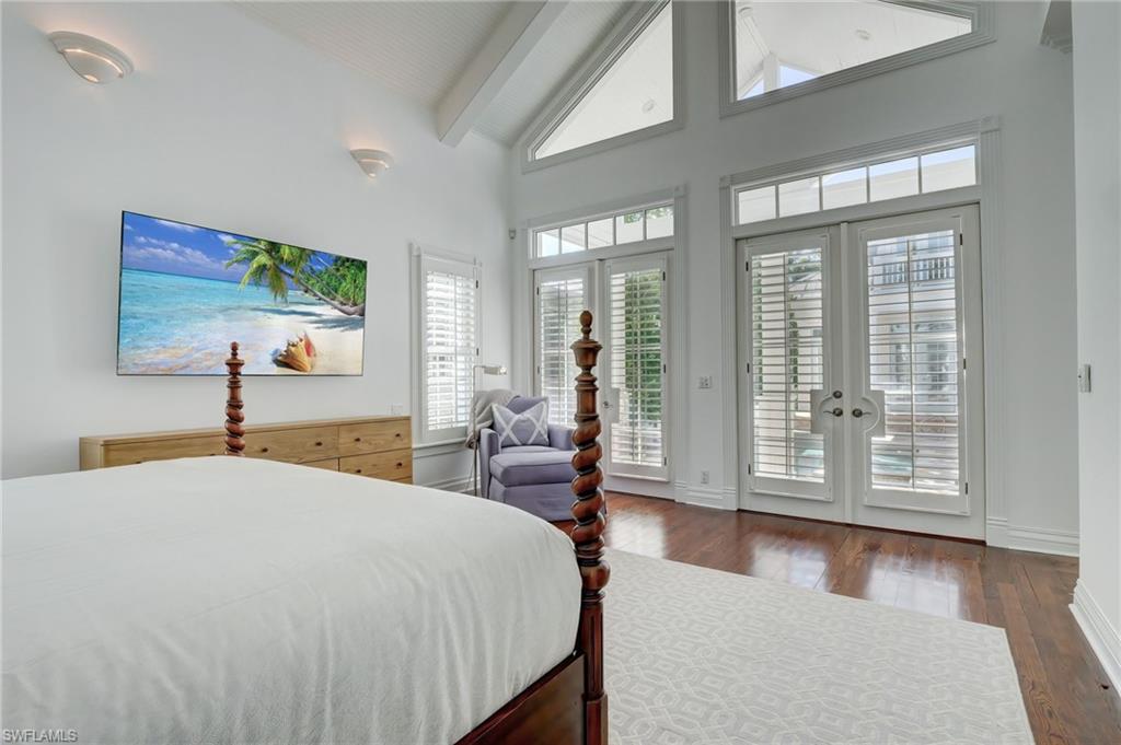 1551 Gulf Shore Boulevard South Naples, FL 34102 - Photo 28 of 44 a spacious bedroom with a large bed and a large window