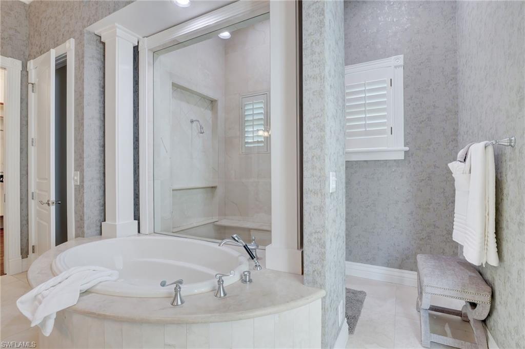 1551 Gulf Shore Boulevard South Naples, FL 34102 - Photo 31 of 44 a bathroom with a tub and shower