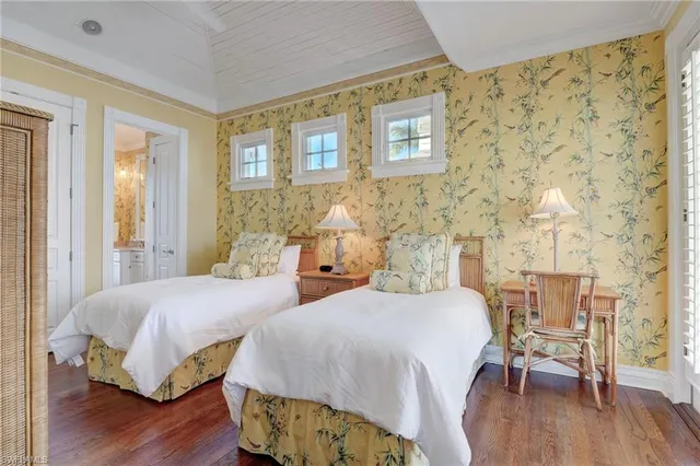 a en suite bathroom with a granite countertop sink and a mirror