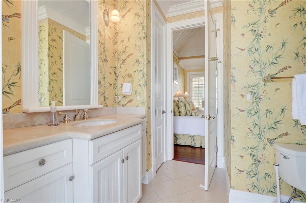 1551 Gulf Shore Boulevard South Naples, FL 34102 - Photo 33 of 44 a en suite bathroom with a granite countertop sink and a mirror