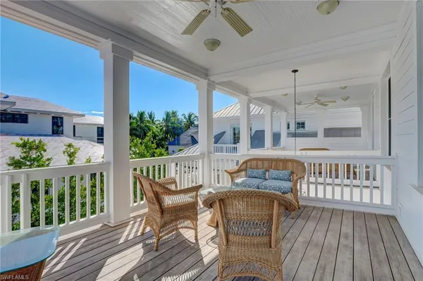 an outdoor living area with furniture and a potted plant