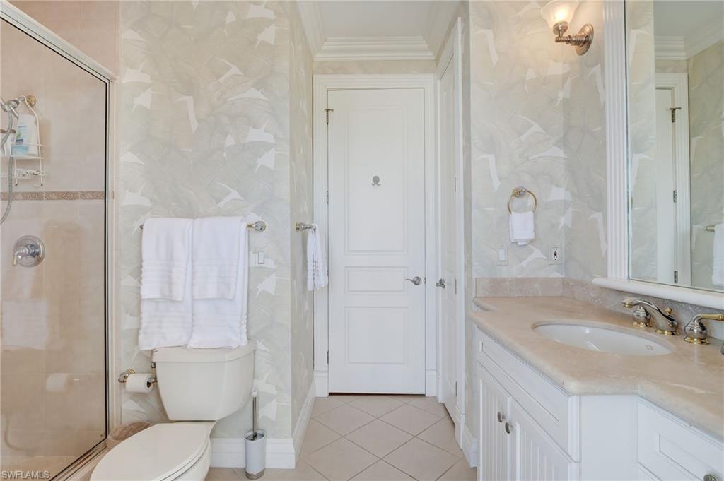 1551 Gulf Shore Boulevard South Naples, FL 34102 - Photo 39 of 44 a bathroom with a granite countertop sink toilet and shower
