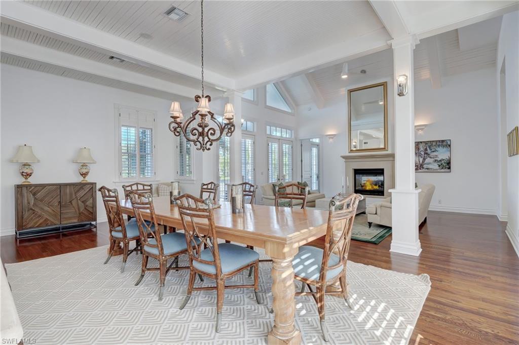 1551 Gulf Shore Boulevard South Naples, FL 34102 - Photo 8 of 44 a view of a dining room with furniture window and wooden floor