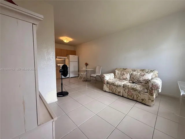 a living room with furniture and a walk in closet