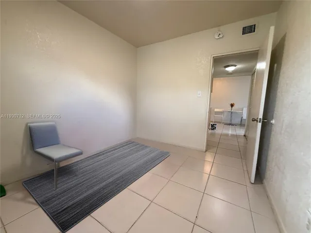 a view of a hallway and wooden floor