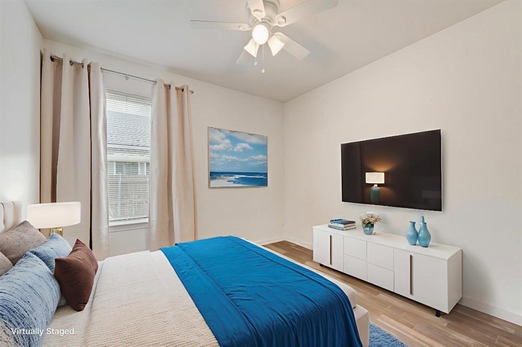 3815 Spence Street Dallas, TX 75215 - Photo 11 of 15 a bedroom with a bed and a flat screen tv