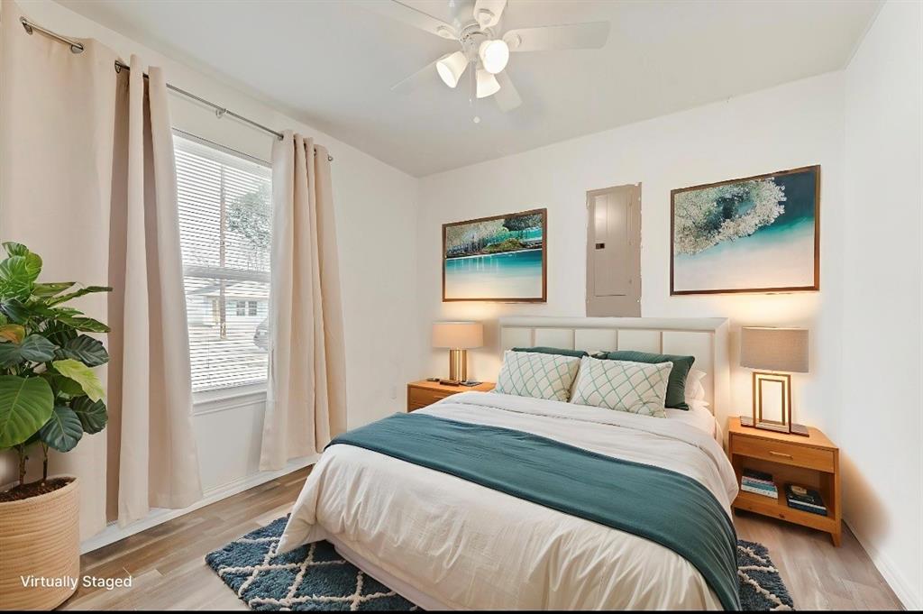 3815 Spence Street Dallas, TX 75215 - Photo 12 of 15 a bedroom with a bed and a potted plant