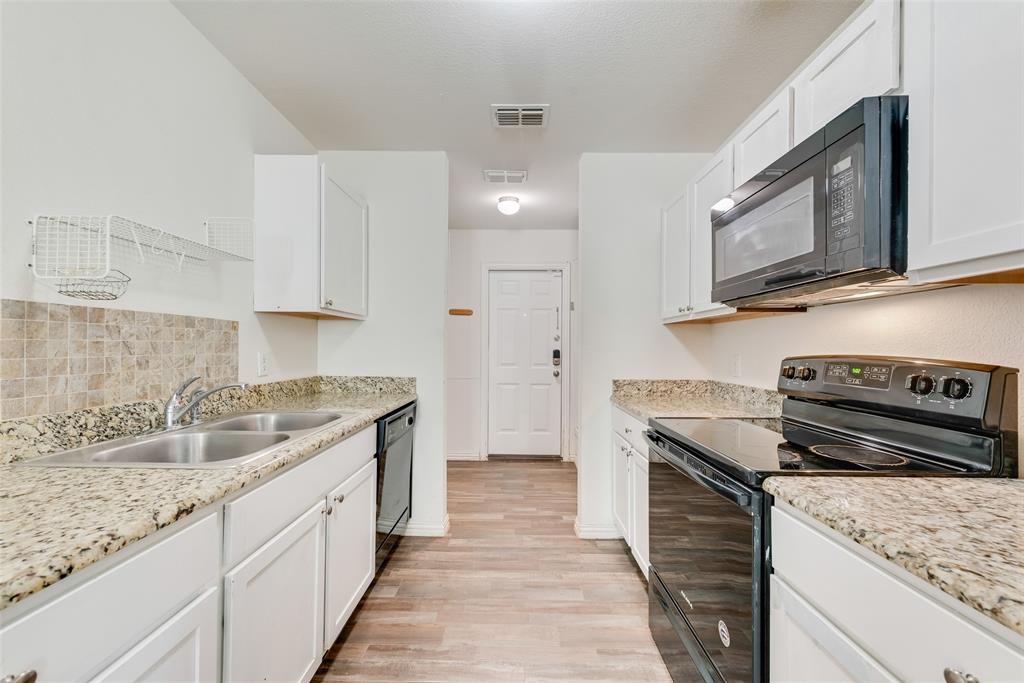 3815 Spence Street Dallas, TX 75215 - Photo 4 of 15 a kitchen with granite countertop a sink stove and cabinets