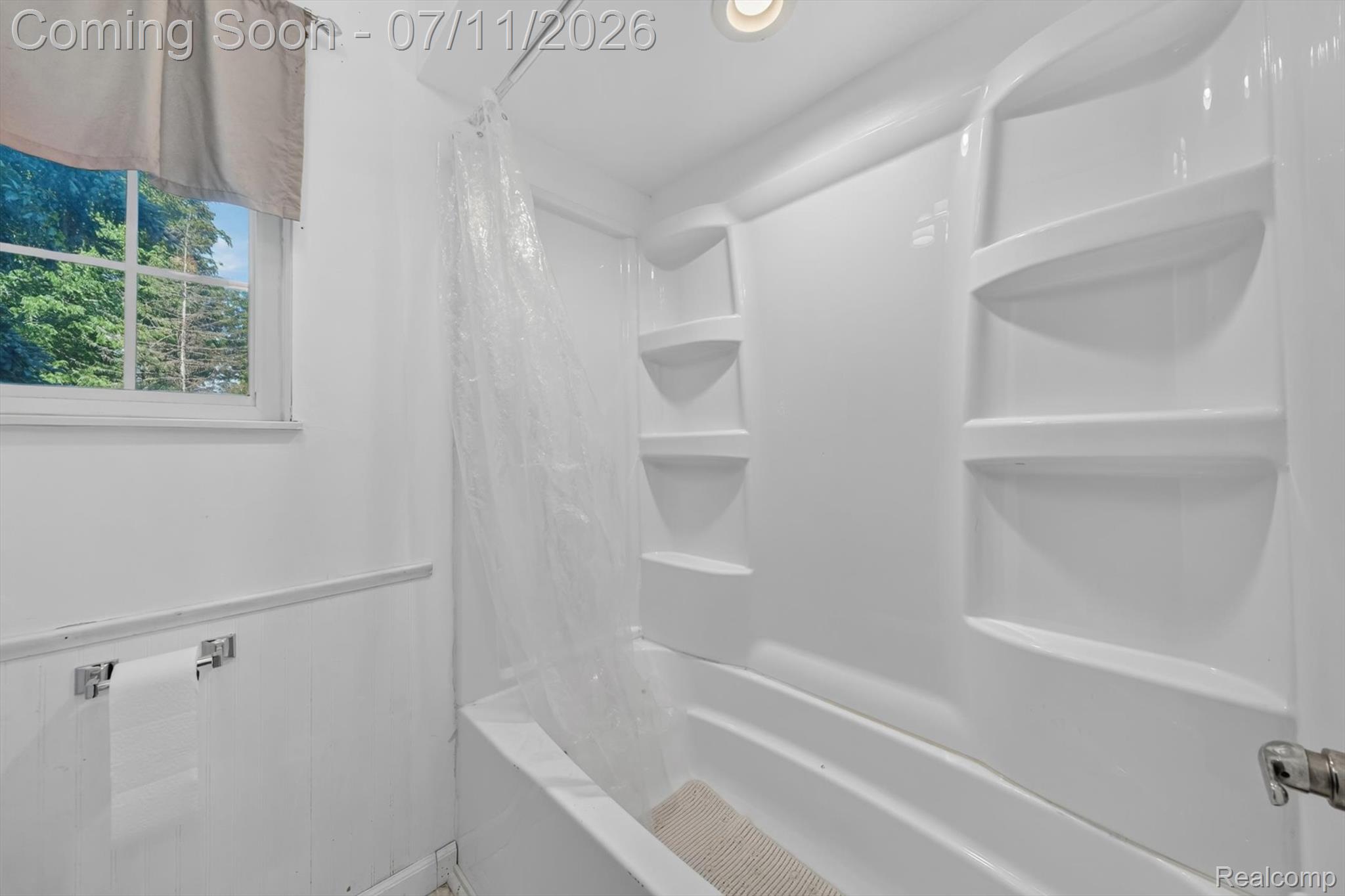 4430 North Center Road Flint, MI 48506 - Photo 16 of 49 White fiberglass tub and shower combination with integrated shelving
