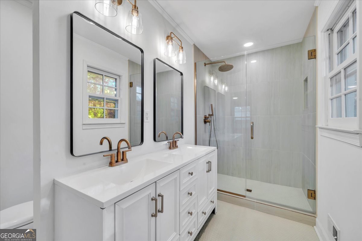 1806 Knox Street Dublin, GA 31021 - Photo 22 of 49 a bathroom with a double vanity sink mirror and shower