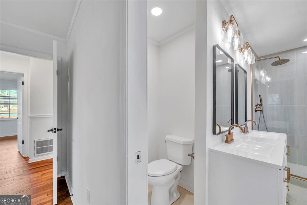 1806 Knox Street Dublin, GA 31021 - Photo 24 of 49 a bathroom with a sink a toilet a mirror and shower