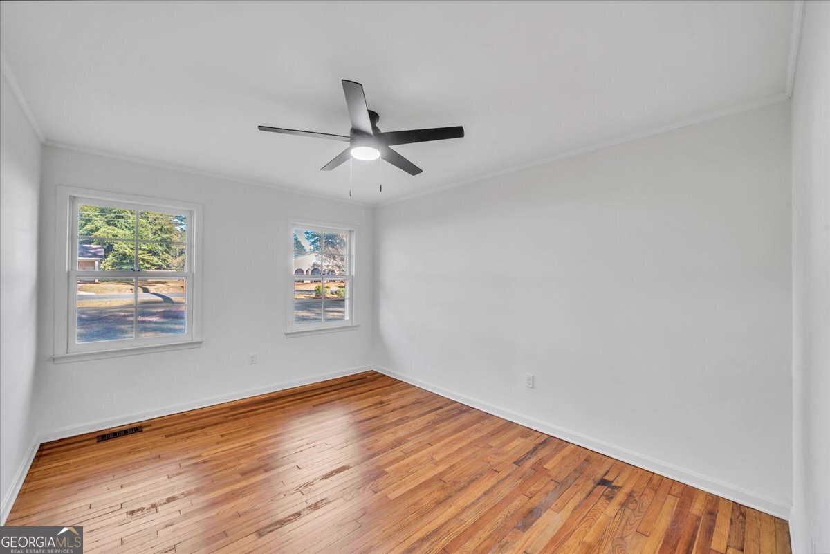1806 Knox Street Dublin, GA 31021 - Photo 27 of 49 a view of empty room with wooden floor and fan
