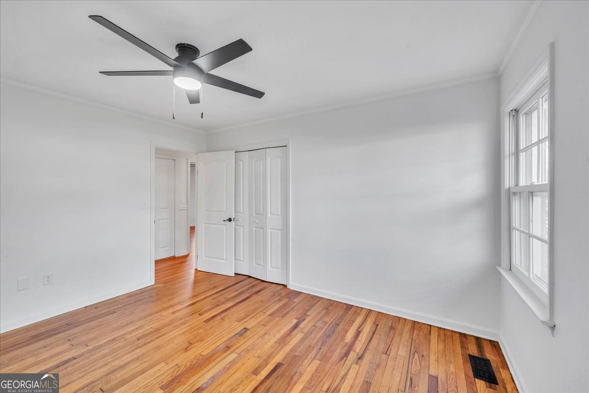 1806 Knox Street Dublin, GA 31021 - Photo 28 of 49 an empty room with wooden floor and windows